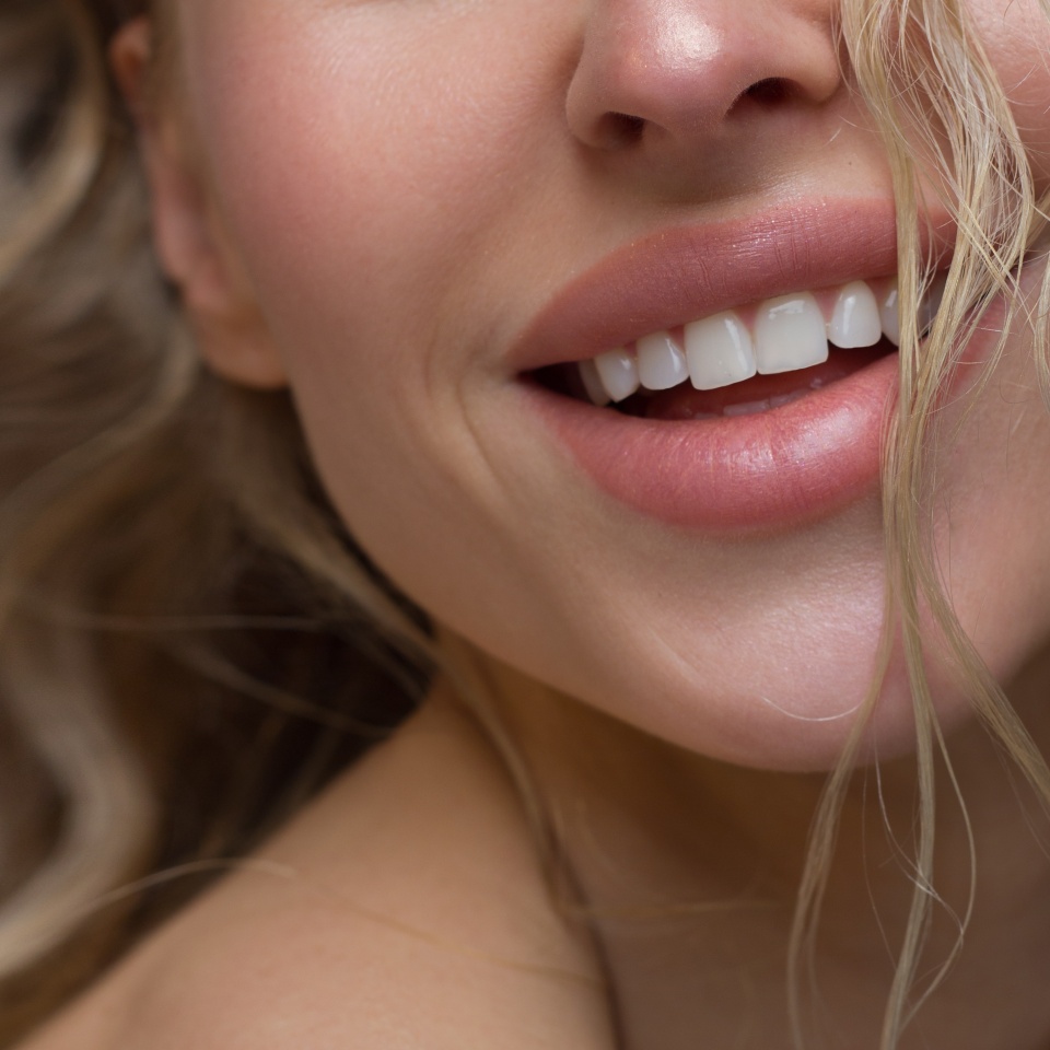 Sexual full lips. Natural gloss of lips and woman's skin. The mouth is closed. Increase in lips, cosmetology. Natural lips. Great summer mood with open eyes. fashion jewelry. Pink lip gloss