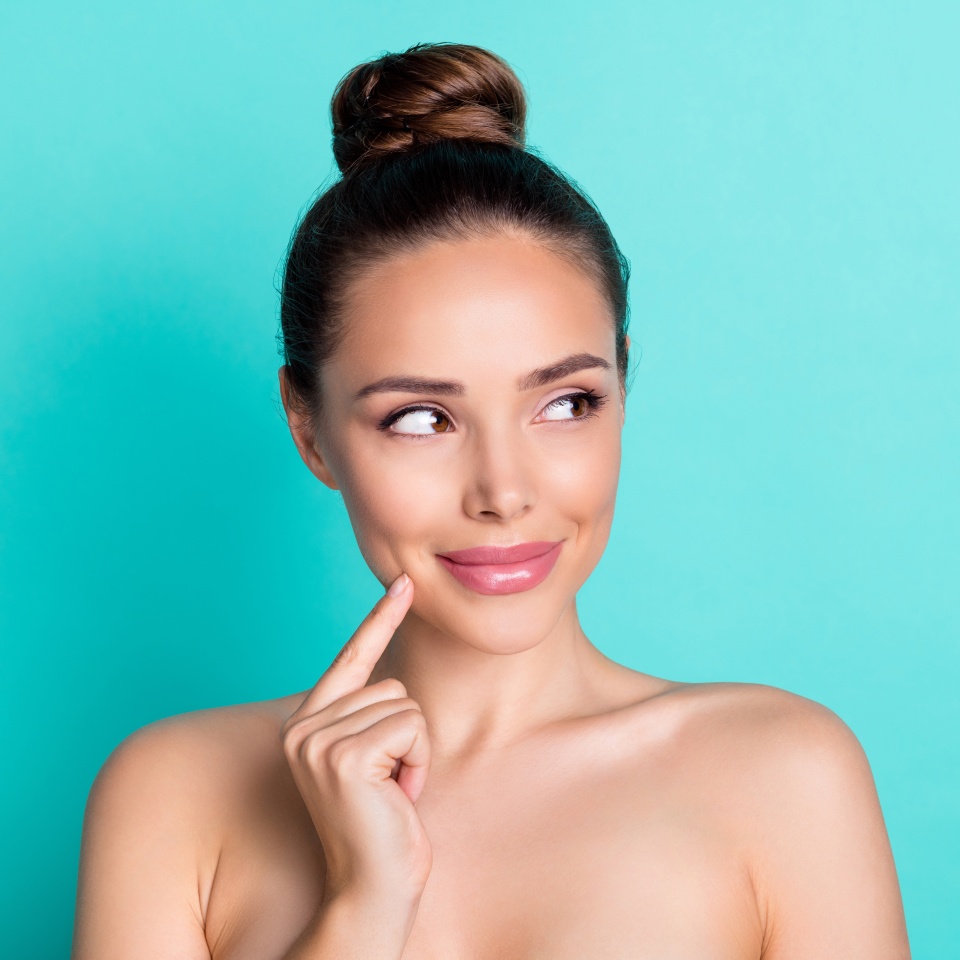 Photo of young beautiful stunning positive girl look copyspace apply moisturizing cream isolated on teal color background