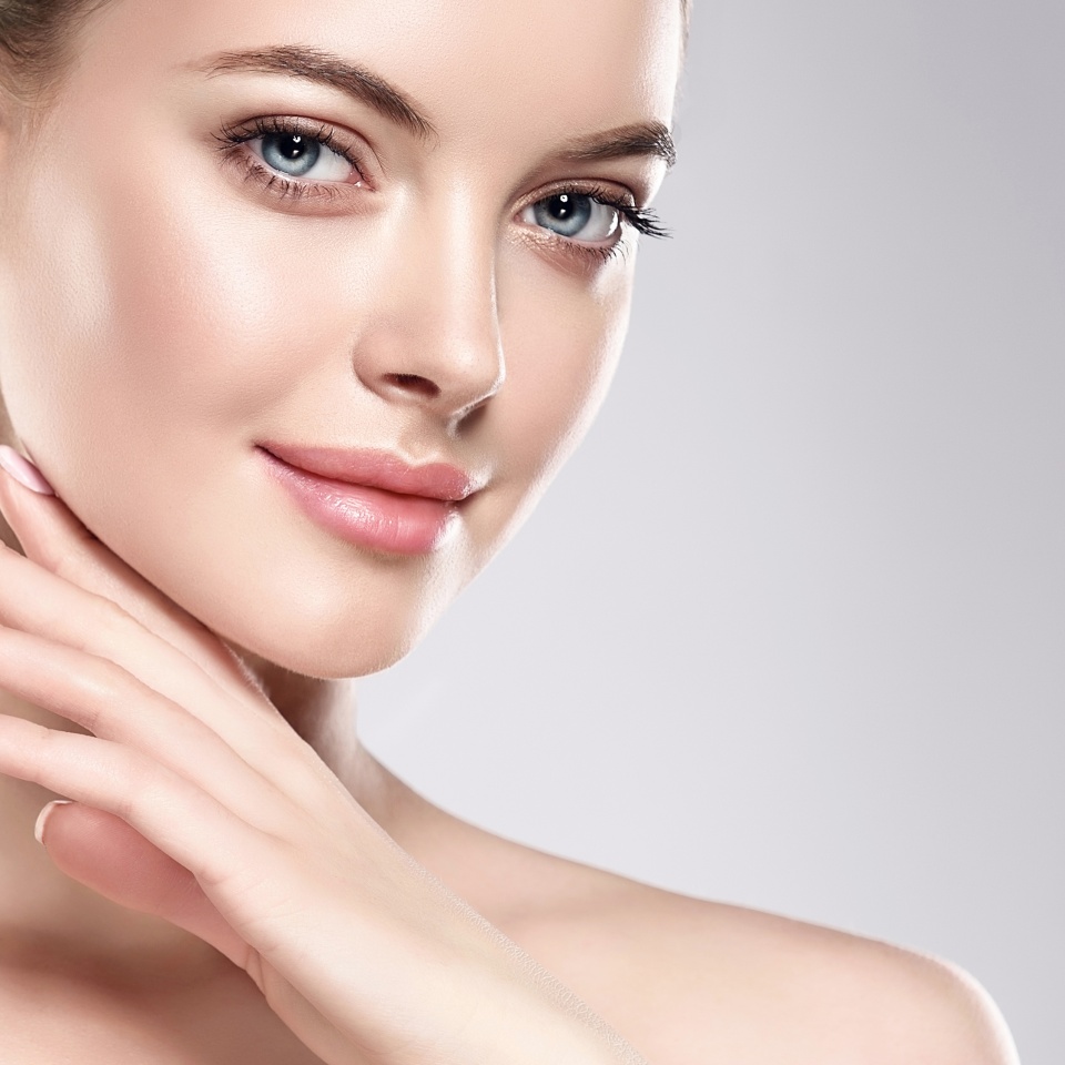 Beautiful Young Woman with Clean Fresh Skin . Facial treatment . Cosmetology , beauty and spa . Skin care